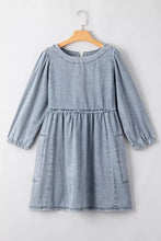 Light blue vintage wash denim dress with long sleeves and two front pockets offering a classic look