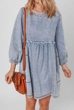 Light blue vintage wash denim dress with long sleeves, ruffled waistband, and pockets