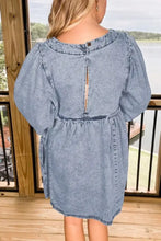 Back view of a vintage wash denim dress featuring light-wash fabric, puffed sleeves, and a zipper detail