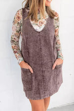 A dusty purple vintage wash denim overall dress with v-neckline and two front pockets in corduroy fabric