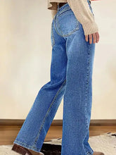 Vintage wash blue denim straight leg jeans with classic stitching details and a wide-leg cut in cotton material