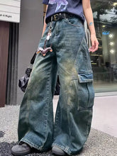 Vintage wash wide leg cargo jeans in faded blue denim with prominent cargo pockets and visible stitching