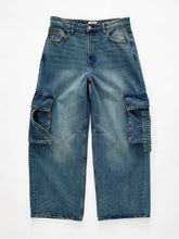 Vintage wash wide leg cargo jeans in blue denim featuring large side pockets and a relaxed fit