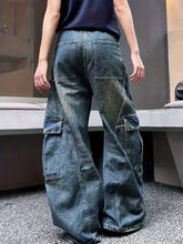 Vintage wash wide leg cargo jeans in dark-wash denim featuring wide legs and multiple functional pockets