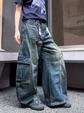 Vintage wash wide leg cargo jeans in faded blue denim with large cargo pockets for a casual look