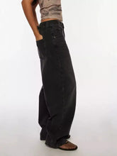 Black vintage wash wide leg jeans in denim with a relaxed tapered fit and visible stitching details