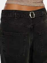 Black denim vintage wash wide leg jeans with a silver-toned buckle and subtle texture in durable material