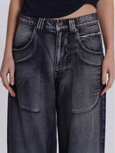Dark gray wide leg denim jeans with vintage wash faded finish and frayed pocket edges