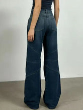 Dark indigo denim vintage wash wide leg jeans with high-rise cut and diagonal seam detailing