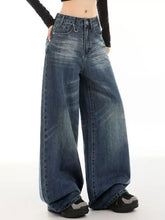 Vintage wash wide leg denim jeans in faded medium blue with classic stitching and button fly closure