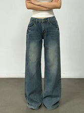 Vintage wash wide leg denim jeans in faded medium-blue with classic stitching and button fly closure