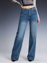 High-waisted blue denim vintage wash wide leg jeans with classic stitching and a wide leg cut