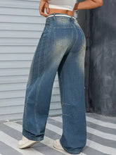 Vintage wash wide leg high waisted denim jeans in medium blue with subtle fading and distressed details
