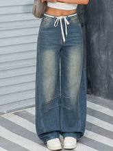 Vintage wash wide leg high-waisted denim pants in medium blue with white drawstring waistband