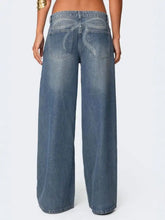 Vintage wash wide leg jeans in medium-wash blue denim with subtle fading and distressed details