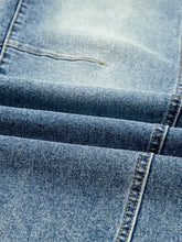 Light-wash denim vintage washed seam shift jeans with visible stitching and textured faded fabric detail
