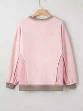 A soft pink waffle color block patchwork loose sweatshirt with beige trim and subtle textured panels featuring sequin christmas light design