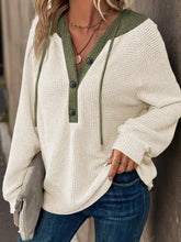Cream-colored waffle knit button detail drawstring hoodie with olive green trim in slightly stretchy material
