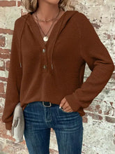 A cozy brown waffle knit button detail hoodie with three front buttons and drawstrings including care instructions