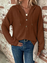A cozy brown waffle knit hoodie with v neck and waffle knit button closure featuring care instructions
