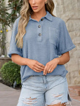 Light blue waffle knit polo shirt featuring three dark waffle knit buttons and a chest pocket