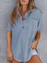 Light blue waffle knit short-sleeved shirt with button front and chest pocket in a waffle knit button detail top
