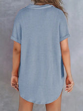 A light blue waffle knit short-sleeved shirt dress with collar, rolled cuffs, and waffle knit button detail