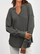 Dark gray waffle knit long sleeve sweatshirt with keyhole neckline and ruffled cuffs, slightly stretchy, machine wash cold tumble dry low