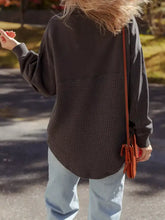 A dark gray waffle knit patchwork half zipped casual sweatshirt with textured lower half and machine wash cold care