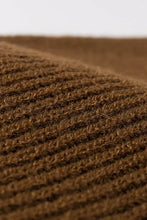 Close-up of brown ribbed warm winter knit beanie fabric