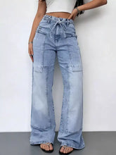 Light-wash denim wash wide leg cargo jeans with high-rise, drawstring waist, and multiple patch pockets