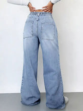 Light-wash denim wash wide leg cargo jeans with high-rise relaxed fit and visible stitching details