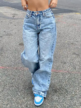 Light-wash denim wash wide leg jeans with high-rise fit and frayed cuffs in a wide leg cut style