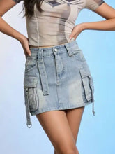 Light-wash denim skirt with multiple pockets and adjustable side straps in a washed cargo denim style