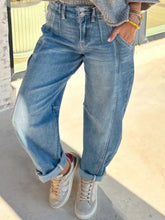 High-waisted light blue denim washed cuffed barrel jeans with a relaxed tapered fit and rolled cuffs