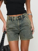 Washed high rise denim shorts with faded black fabric and exposed button closure