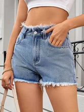 Light wash raw hem denim shorts with frayed waist