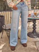 Light-wash denim high-rise wide leg jeans with classic five-pocket design in a washed finish