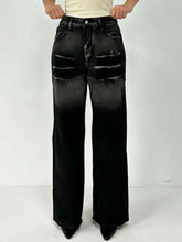 Black washed wide leg denim jeans with distressed ripped details on thighs featuring a washed wide finish