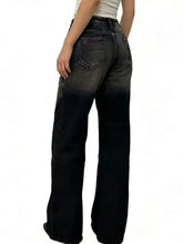 Black washed wide leg jeans showing the back side with faded wash and classic denim pockets