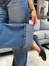 Blue denim washed wide leg jeans with a rolled cuff and subtle fading detailing in wide leg jeans style