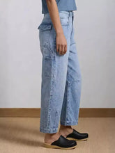 Light-wash denim washed wide leg jeans with multiple pockets and a relaxed wide leg cut cargo style