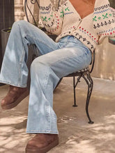 Light-wash denim wide leg jeans with relaxed fit and classic stitching in a washed wide leg style