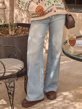Light-wash denim washed wide leg jeans featuring a relaxed flare and classic stitching with a straight leg cut