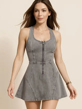 A fitted sleeveless gray washed denim mini dress with front zipper and flared skirt perfect as a denim mini dress