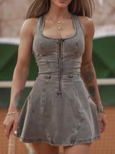 A fitted gray denim mini dress with a front zipper and structured seams in a washed zip-front style