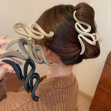 Wavy matte acrylic hair claw clip set in beige, black, and brown