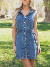 Blue denim sleeveless dress featuring button front and decorative belt buckles in a western belt design denim dress