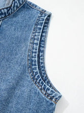 Blue denim sleeveless dress with western belt button down and curved hem featuring contrasting stitching
