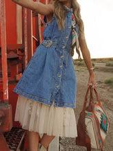 Blue sleeveless denim dress with button front and decorative western belt buckle in short design